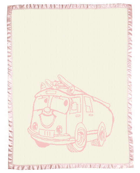 Merino baby blanket with pink fire truck design, birth details, and pink satin border on natural background.